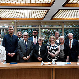 Photo of a group of adults sitting behind a table.