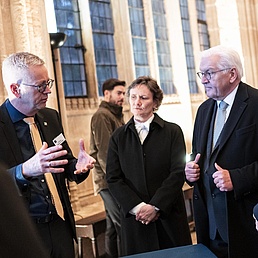 People listening to a man who is speaking