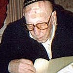 Kleinmann with kippah, glasses, reading a book
