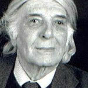 Black and white photograph by Gerhard Kalkmann, he looks into the camera and smiles slightly. Black and white photograph by Gerhard Kalkmann, he looks into the camera and smiles slightly.