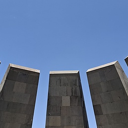 A blue sky in the upper part of the picture. In the lower part, five smooth stone blocks.