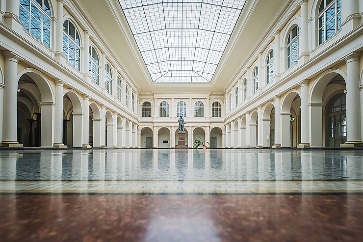 Campus Nord Der historische Thaer-Saal der HU mit Marmorfußboden, links und rechts Säulenarkadengängen, Thaer-Denkmal und großem Glasdach